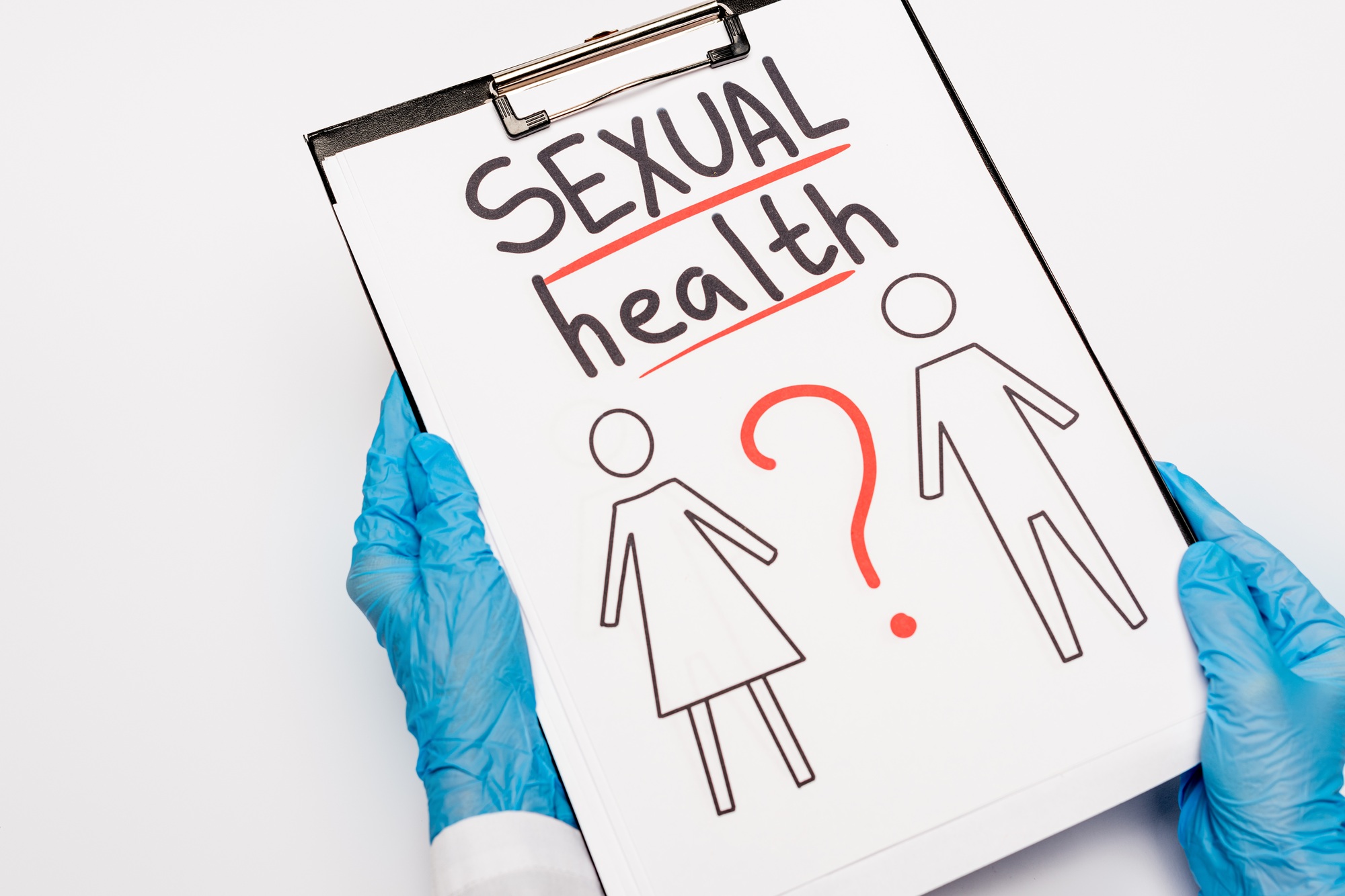 cropped view of doctor in blue latex gloves holding clipboard with sexual health lettering, drawn